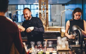 Bartenders making drinks drinks for patrons