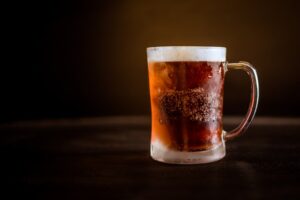 Top Beers for Christmas UK; A beer mug filled with chilled, dark beer.