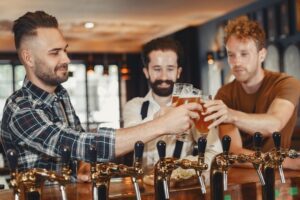 pub improvements for 2022; three men drinking beer together.