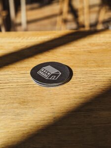 beermats placed on a wooden table.