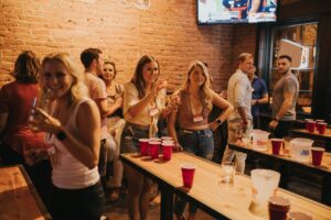 sports bar promotion tips; people playing at the bar