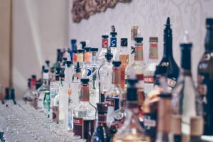 bar design tips; bottles and glass placed on shelves