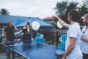 games for Oktoberfest parties; people playing beer pong