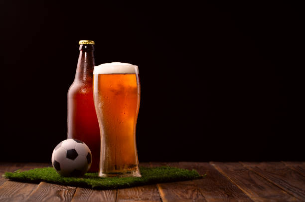 bar ready for the world cup; a small football and a glass of beer