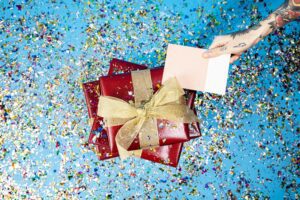 creative holiday promotions; a gift card placed on top of gifts