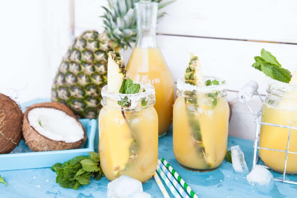 Valentine’s day cocktails, pineapple and coconut cocktails in jars.