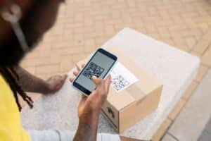 personalized packaging, a man scanning a QR on his mobile from a package