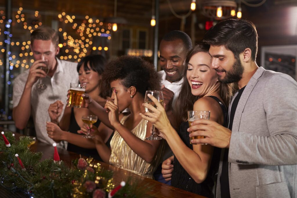 Christmas bar marketing, group of people celebrating Christmas at a bar.