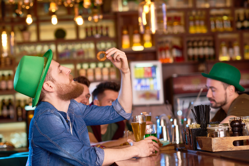 St. Patrick’s Day drink and menu ideas, people in green hats at a bar.