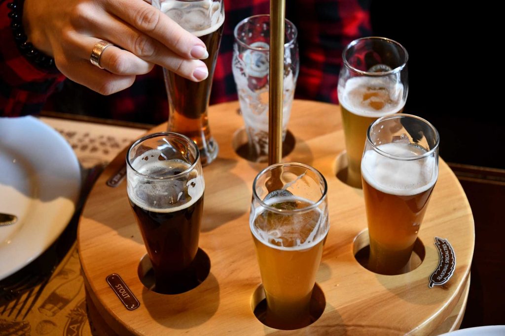 how to host a beer tasting party, multiple beer samples on a sampling board